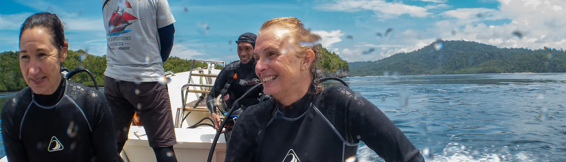 Scuba divers on a speedboat ready to dive