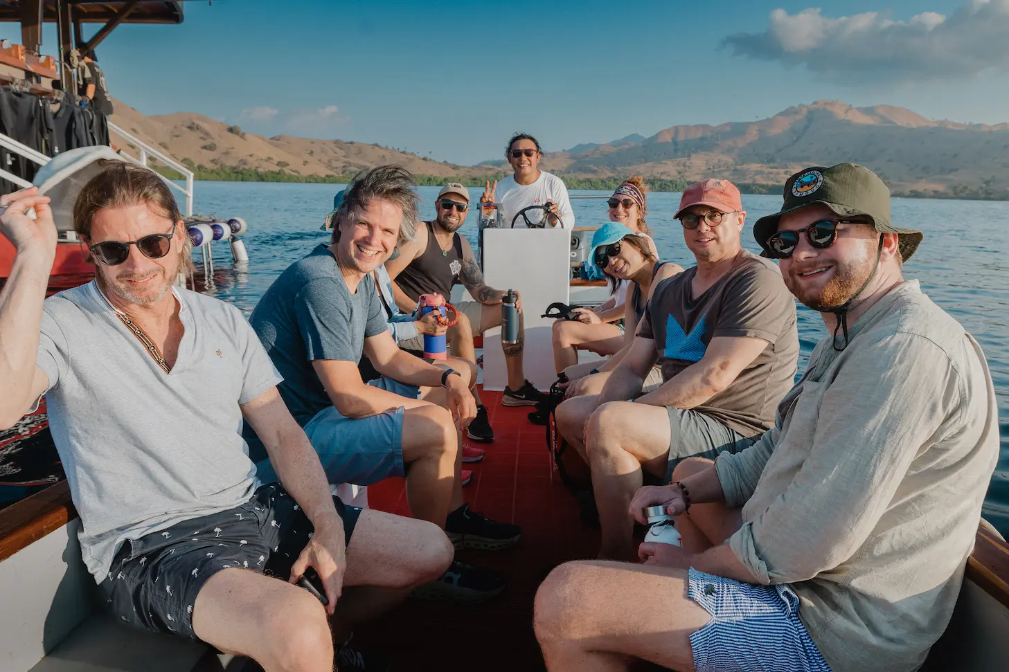 liveaboard guests posing on la galigo's speed boat