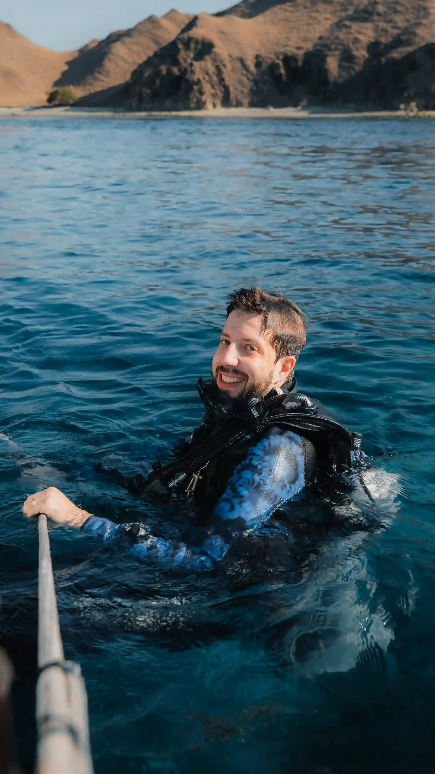 Scuba diver smiling on water surface after a great diving session