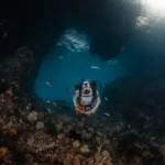 scuba diver posing for the camera while diving in Raja Ampat